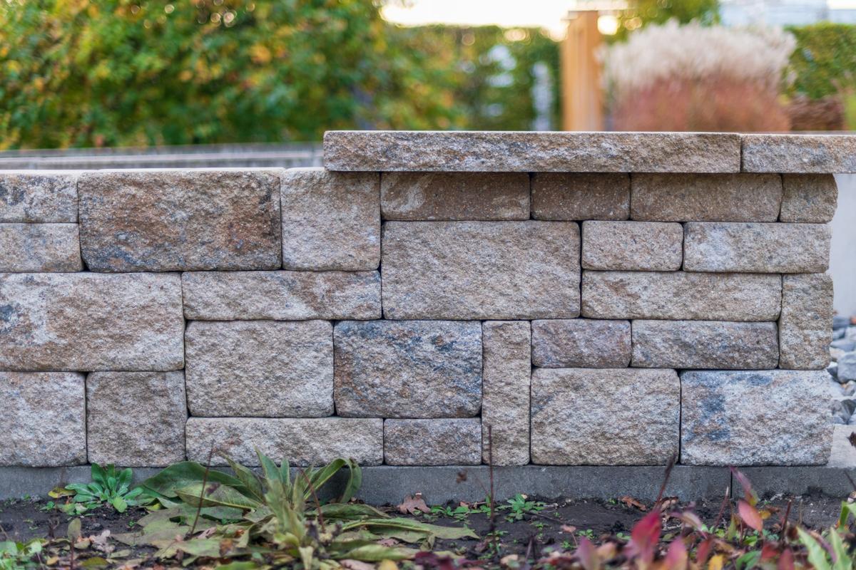 Capped block retaining wall